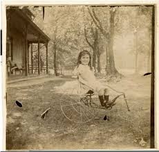 Ruth Blakey with her dolls and doll carriage in front of 805 S. Center St, circa 1896. Ruth Blakey on her tricycle, circa 1987. - Ruth-Blakey_tricycle_1897-1-430x409