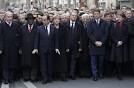 French, foreign leaders walk arm-in-arm as millions protest Paris.