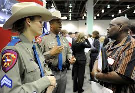 Texas Department of Public Safety Corporal Arminda Henke, left, and Trooper Deon Cockrell talk to Donello Phillips of Detroit, who is looking for a job. - 20090519113417_010