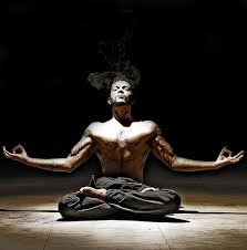 A man posing in a lotus position