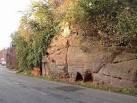 A garage or store has been made out of a cave or overhang in the rock - via Daymix