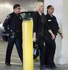Gwen Stefani leaves with a police escort after taking her family