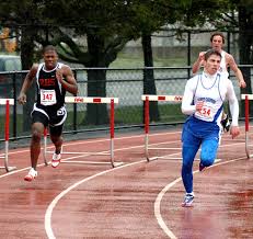 Lower Dauphin\u0026#39;s Rodney Still takes the 300 Hurdles in 44.99. You don\u0026#39;t have to tell Erica Rossum of Central Dauphin that it\u0026#39;s a little damp outside. - 040205_Bdallas15