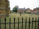 Hose, Leicestershire. Sheep grazing the church yard with the school beyond. - via Daymix