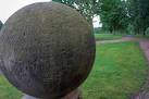 One of a pair of sandstone balls at the entrance to the stable block and - via Daymix
