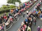 Iron Man Competition, Tenby. Athletes being cheered on by spectators as they - via Daymix
