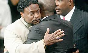 Bishop Eddie Long embraces a