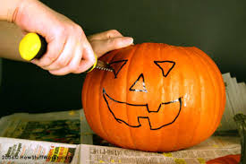 carving out the pumpkin design