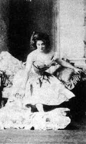 Anna Held on a small sofa,