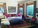 Boho living room. Great jewel tones, layered rugs, lots of t ...
