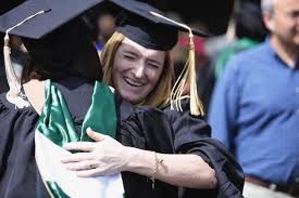... Eastern Michigan graduate Colleen Brophy, hugs a fellow graduate following commencement, outside the Convocation Center in ... - EMU-12_display