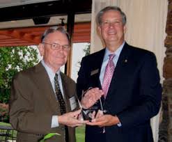 Gene Roberts, left, accepts the North Carolinian of the Year award from NCPA President Tim Dearman of Statesville Friday in Asheville. Jock Lauterer photo - generoberts