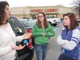 Mikayla Long, from left, explains to her friends Eilish Flannery and Amy Malo the moral dilemma thrust upon Hobby Lobby, a Christian-owned company that ... - 130101-From-left-Mikayla-Long-Eilish-Flannery-Amy-Malo-Nooganomics.com_1