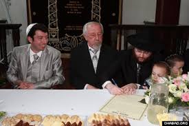 At the same time, Ran Fridman, left, takes part in a pre-wedding ceremony presided over by ... - PRvb4262065