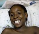 Dany Love St. Cloud, 8, a victim of the school collapse, in her bed at the ... - 539w
