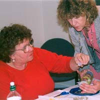 Linda Astore decorates a candle with assistance from Mary Bedient-Wood, Bereavement Care Coordinator for HospiceCare In The Berkshires. - 14136