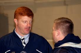 Mike McQueary talks with a