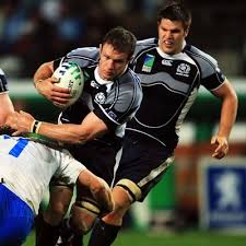 THis is a picture of men one team tackling the other team in rugby