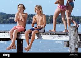 young little naked kid boys an girls|Small naked boy on a swing in the garden Stock Photo - Alamy