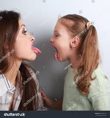 mother daughter tongue|Beautiful family of mother and daughter together at home sticking tongue  out happy with funny expression. Emotion concept Stock Photo - Alamy