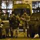 Paris attacks: Belgium police still hunting two suspects after raid 