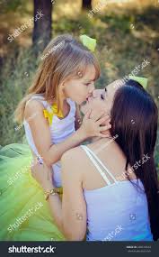 moter daughter oiss|Mother and daughter kissing outdoors stock photo