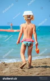 Little topless girl on beach|Girl Making Sand Castles - Stock Photos | Motion Array