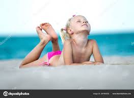beach little garl|Little girl playing with sand on beach. Enjoying a lovely vacation Stock  Photo - Alamy