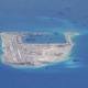 US warship sails by South China Sea reef, irking Beijing 