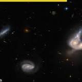 Here's a stunning picture of 2 merging galaxies 671 million light years away