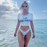 Kim Kardashian Posts Sexy Seaside Photo Shoot in 'Incredibles' Tee and Risqué Bikini Bottoms